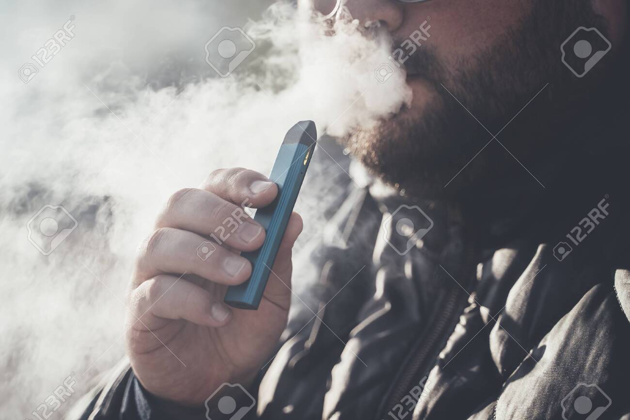 A person inhaling vapor from a dab rig.